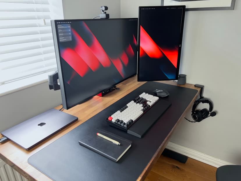Close-up view of Shane's desk showing Keychron keyboard and monitor details