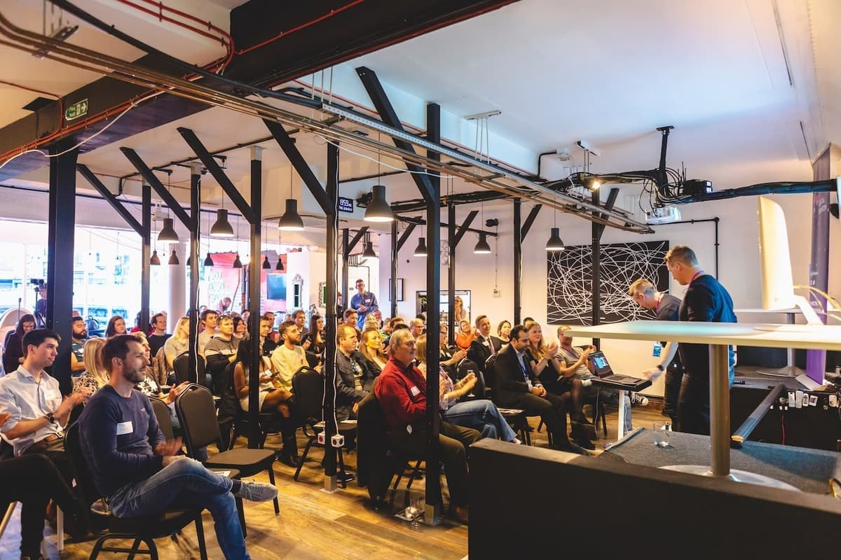Shane speaking at a conference presenting to a packed audience