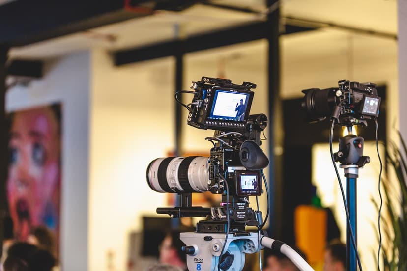 Shane presenting on stage with professional lighting and conference branding