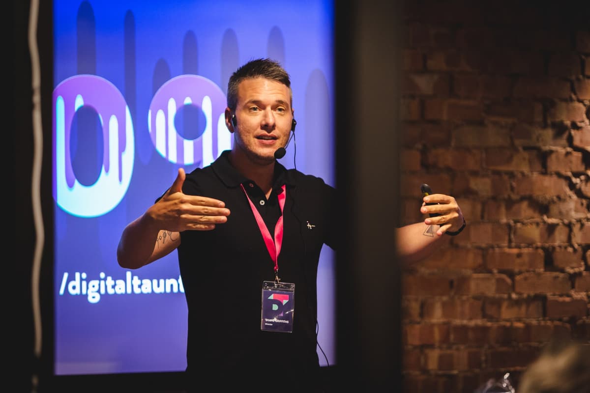 Shane speaking at a tech event with audience engagement